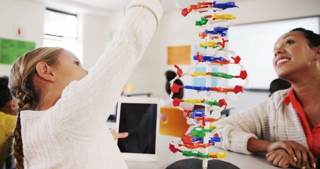 Young Student Learning About DNA Model with Teacher in Classroom Setting - Download Free Stock Images Pikwizard.com