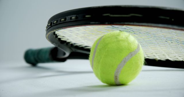 Close-Up of Tennis Racket and Yellow Tennis Ball on White Surface - Download Free Stock Images Pikwizard.com