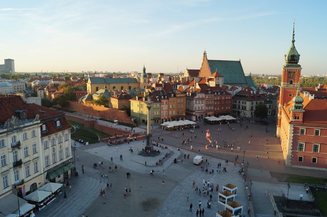 Old Town Square in Warsaw during sunset with tourists - Download Free Stock Photos Pikwizard.com