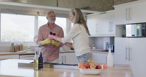 Mature Couple Engaging in Joint Kitchen Cleaning Activity