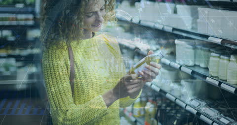 Woman Examining Product in Supermarket with Digital Data Overlay
