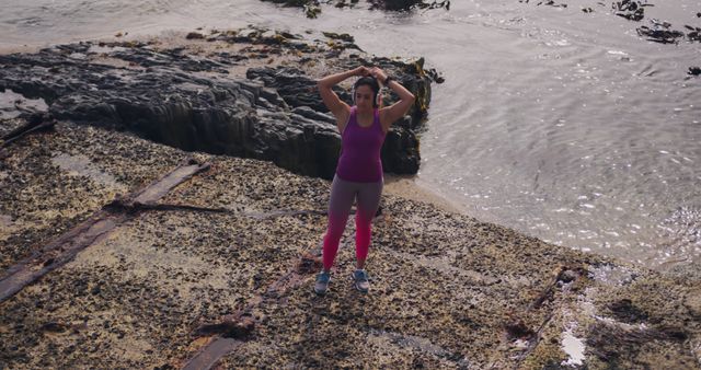 Active Woman Stretching on Rocky Shoreline - Download Free Stock Images Pikwizard.com