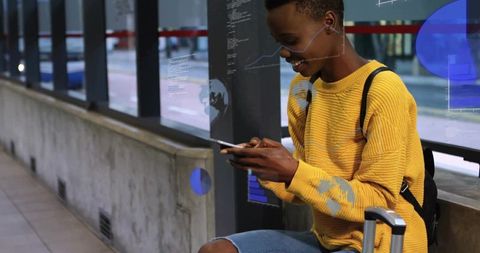 Modern Commuter Engaged with Smartphone at Station
