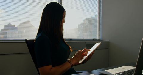 Caucasian Businesswoman Using Tablet in Modern Office Setting - Download Free Stock Images Pikwizard.com