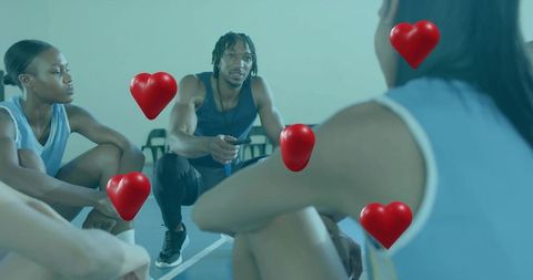 Kneeling Coach Motivating Basketball Team During Timeout Huddle With Heart Icons