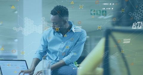 Businessman Typing on Laptop with Digital HUD Overlay in Open-Plan Coworking Office