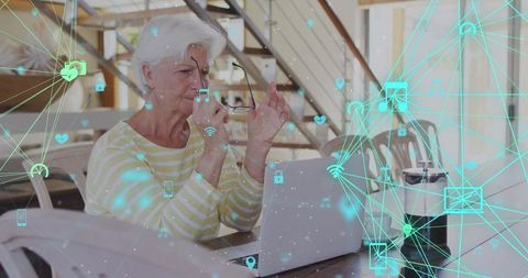 Senior woman engaging with digital technology network at home