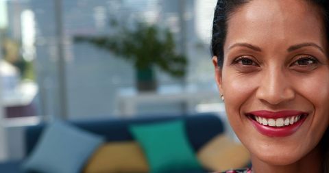 Confident Professional Businesswoman Smiling Indoors with Copy Space