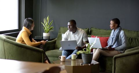 Diverse Team Collaborating in Modern Office Lounge with Laptops - Download Free Stock Images Pikwizard.com