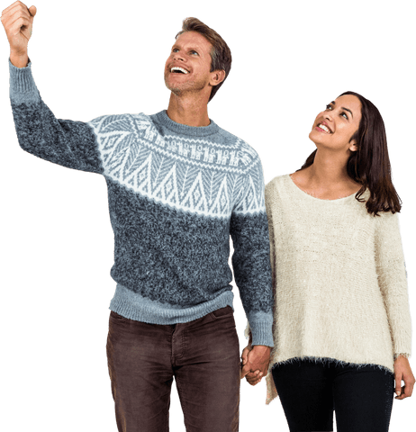 Joyful couple holding hands wearing warm cozy sweaters transparent background