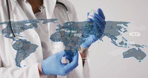 Medical professional holding vaccine vial and syringe with global data map overlay