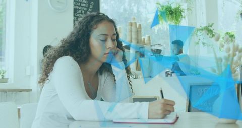Young Woman Writing in Cozy Cafe Environment