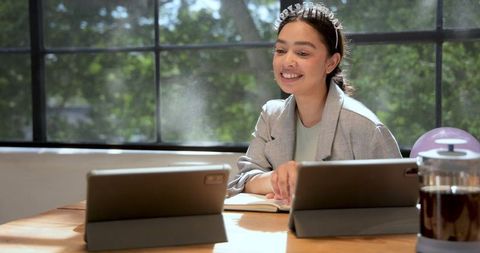 Woman Video Conferencing from Home with Coffee