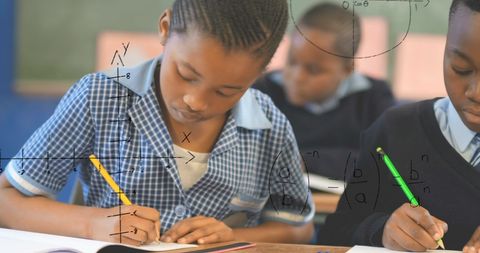 Focused Schoolchildren Studying Math with Formulas Overlay - Download Free Stock Images Pikwizard.com