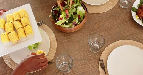 Plates of Color: Enjoying Corn and Salad Around the Dinner Table