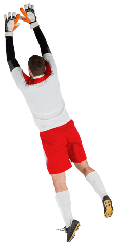 Goalkeeper Wearing White Uniform with Red Accent Jumping for Save - Download Free Stock Videos Pikwizard.com