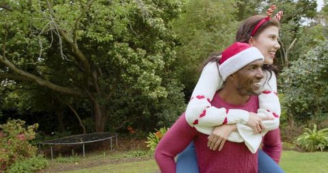 Festive couple glee in sunny holiday garden setting