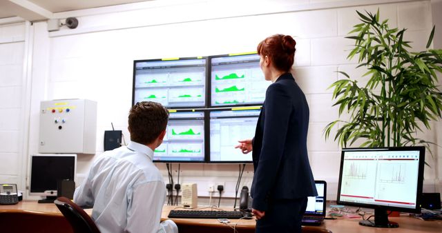 Business People Analyzing Data on Multiple Monitors in Office Setting - Download Free Stock Images Pikwizard.com