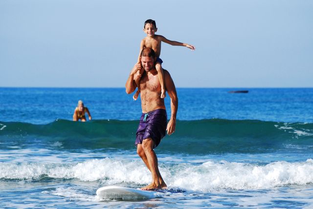 Father and Son Surfing in Ocean - Download Free Stock Photos Pikwizard.com