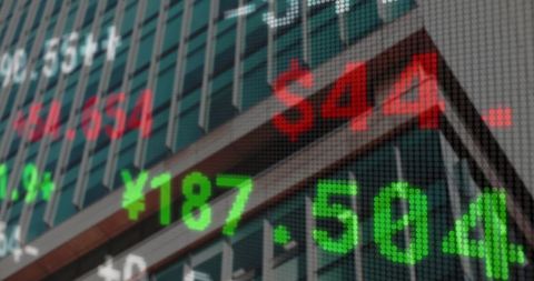 Financial stock market ticker overlaid on urban skyscraper