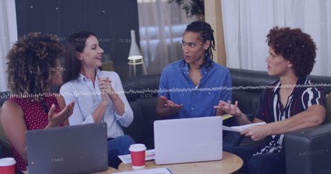 Diverse Professionals Collaborating at Modern Office with Laptops and Coffee