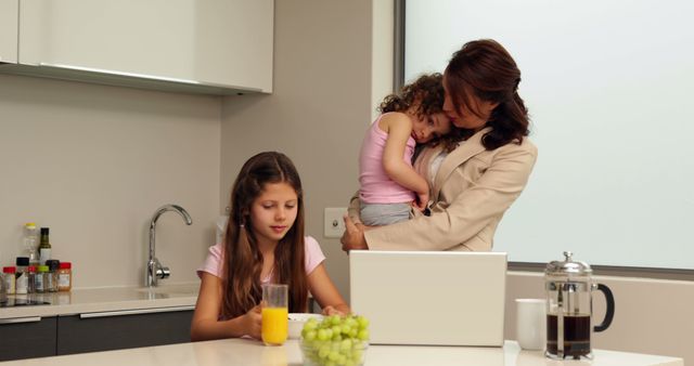 Busy Mom Balancing Work and Family in Modern Home Kitchen - Download Free Stock Images Pikwizard.com