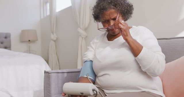 Senior Woman Checking Blood Pressure at Home in Living Room - Download Free Stock Images Pikwizard.com