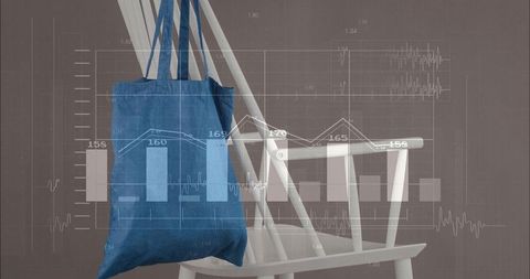 Hanging blue canvas tote bag over white spindleback chair with data graphs overlay