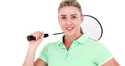 Smiling blonde woman holding badminton racket on white background