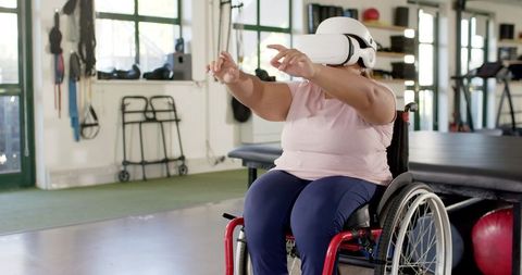 Woman in Wheelchair Experiencing Virtual Reality in Therapeutic Session