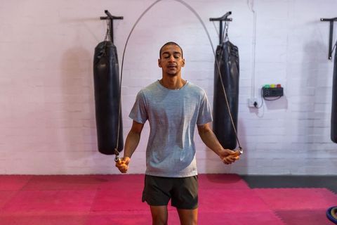 Jumping rope in boxing gym on pink mats boosting cardio, focus and boxing conditioning