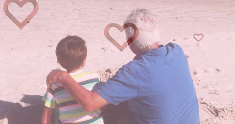 Grandfather Bonding with Grandson on Beach with Heart Designs