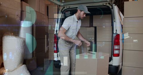 Delivery worker handloading cardboard boxes into van