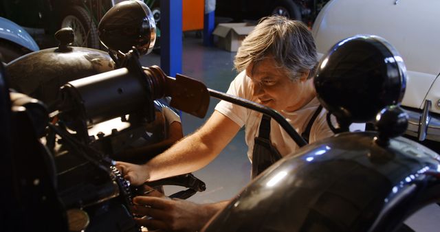 Mechanic Repairing Vintage Car in Garage Workshop - Download Free Stock Images Pikwizard.com