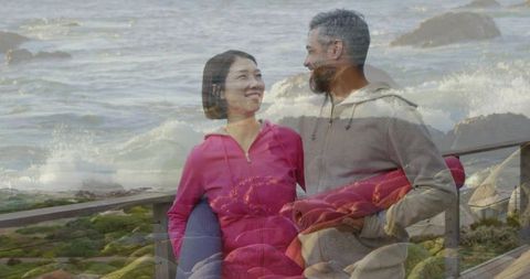 Couple carrying yoga mats on coastal boardwalk double exposure ocean romance wellness