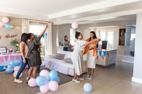 Gathering of friends enjoying celebration with balloons indoors