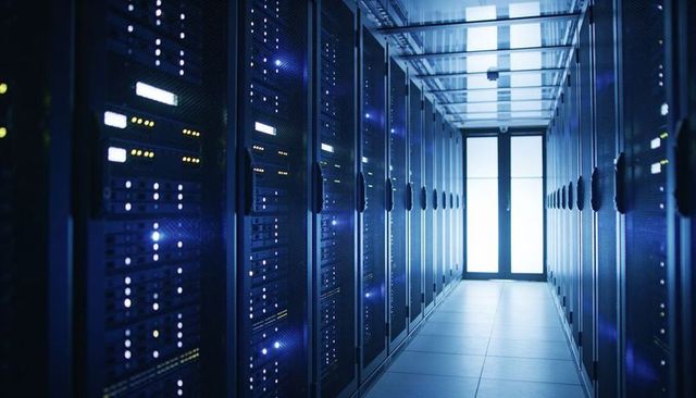 High-tech data center corridor with illuminated server racks and cool blue lighting