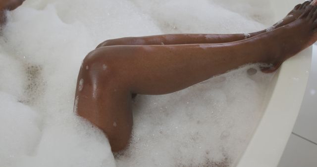 Legs of african american attractive woman relaxing in foam bath in bathroom - Download Free Stock Photos Pikwizard.com