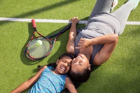 Mother and Daughter Bonding on Tennis Court in relaxing Outdoors
