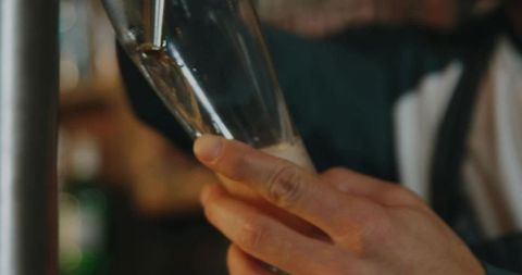 Waitstaff skillfully pouring crisp beer