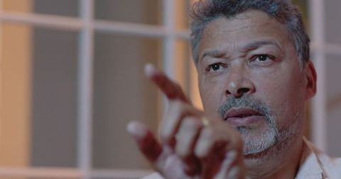 Senior Man Engaging in Thoughtful Conversation at Home