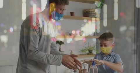 Father and Son Practicing Hand Hygiene with Face Masks On