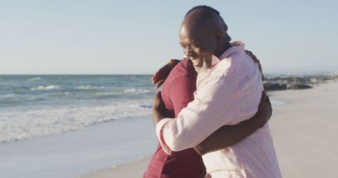 Father and Adult Son Embracing on Peaceful Beach
