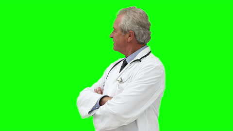 Smiling Doctor in White Coat Looking Backwards Green Screen