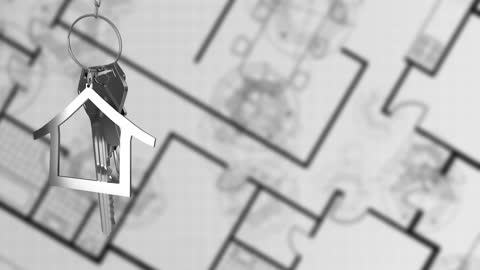 House Key Hanging over Blueprint in Real Estate Concept