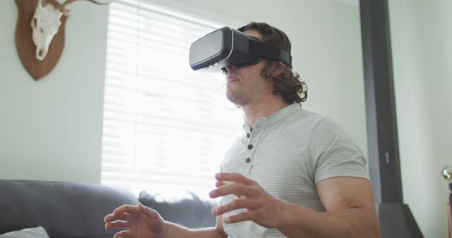 Man Experiencing Virtual Reality With VR Headset at Home - Download Free Stock Images Pikwizard.com