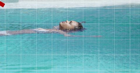 Teen girl floating on back in turquoise pool during sunny day, tranquil minimalist summer