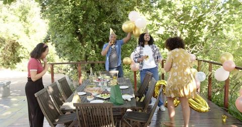 Diverse Friends Celebrating Outdoor Birthday Party on Sunny Terrace