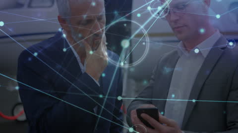 Businessmen Collaborating on Smartphone with Digital Interface Overlay