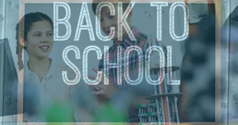 Students smiling behind back to school sign